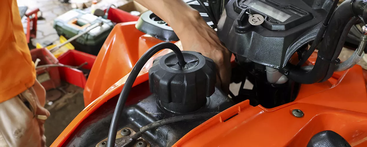 auto mechnics hands working on vehicle in Wood Powersports service bay